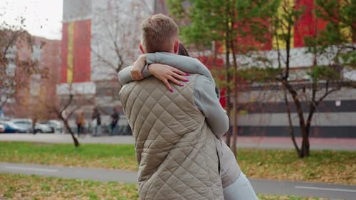 Loving Couple Embracing in Urban Park in Autumn