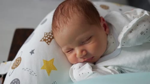 Infant Sleeping Peacefully on Pillow with Star Pattern