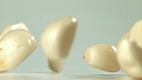 Fresh Garlic Falls on the Table Filmed on a Highspeed Camera at 1000 Fps