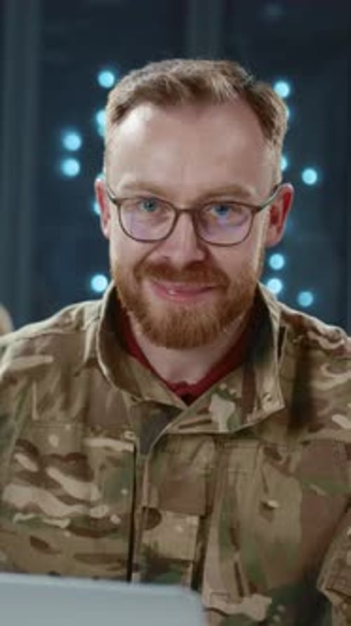 Man in Camouflage Uniform Smiling in Data Center