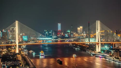 The modern skyscrapers in the city downtown skyline with river bridge under sunset sky