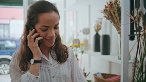 Smiling Businesswoman Call Mobile Phone in Floral Store Office Business Concept