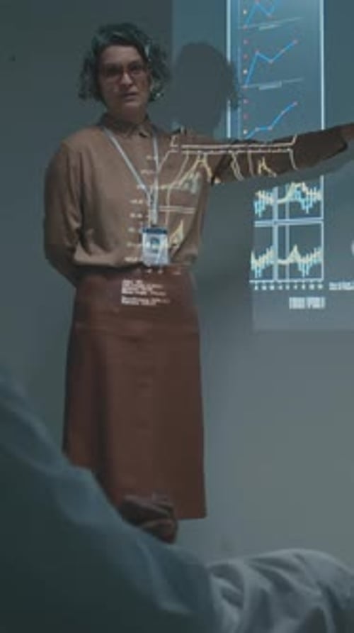 Female Medical Executive Giving Presentation to Doctors at Staff Meeting