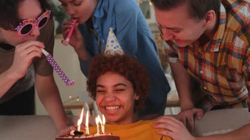 Friends Celebrate Birthday with Cake and Candles