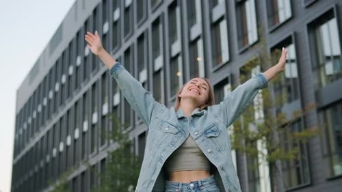 Satisfied Young Woman Widely Smiles Raising Arms Upward