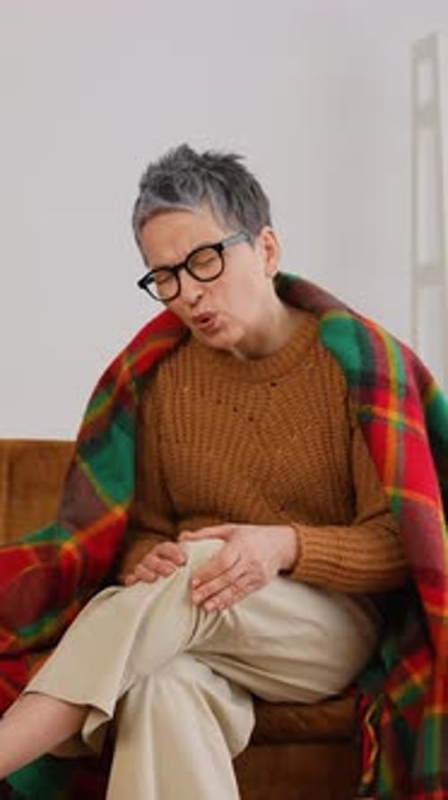 Elderly Woman Suffering From Sharp Knee Pain