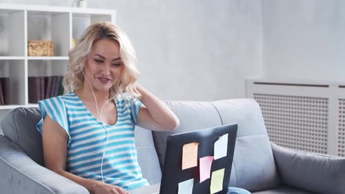 Young and Attractive Woman Works at Home Using Laptop Computer Freelancer or Student Has Online