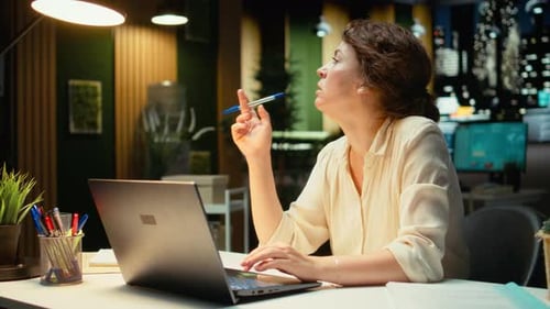 Woman Working Late at Computer in Office