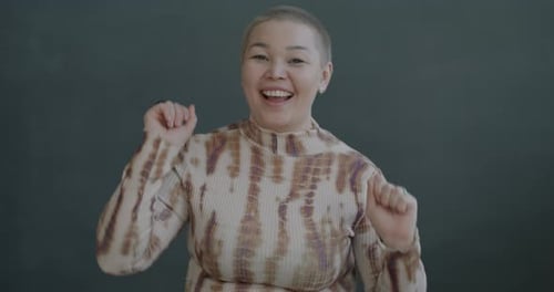 Smiling Young Adult Dancing and Looking at Camera