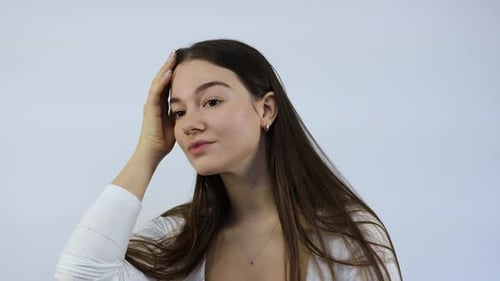 Young Woman Applies Cream to Face Close Up
