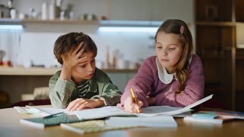 Girl Writes While Boy Rests Head on Hand