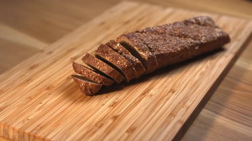 Sliced Whole Grain Bread on Wooden Cutting Board Media