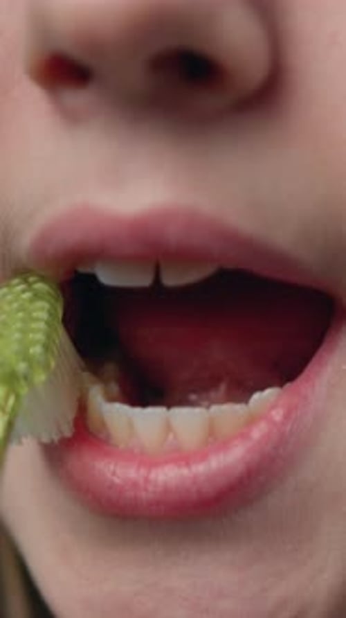 Close Up of a Teenage Girl Brushes Her Teeth with an Toothbrush with Toothpaste Orthodontic