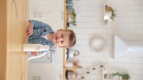 Adorable Child Drink Milk or Yogurt Through an Ecological Straw Vertical Video Concept of Conscious