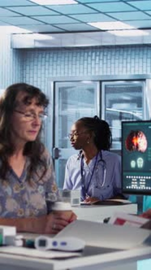 Vertical Video Medical Expert Examines a Cancer Screening Scan with a Patient