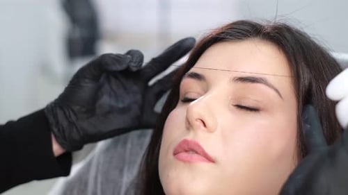 Woman Having Eyebrow Shaping Treatment
