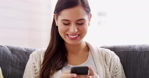 Woman, laugh and typing with phone on couch, reading funny social media post