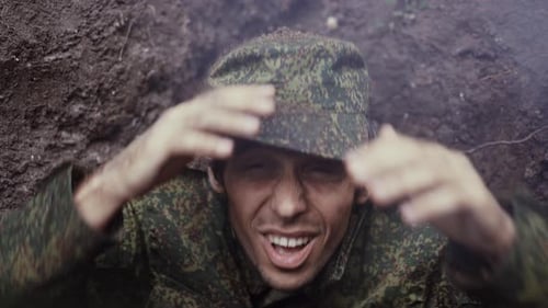 Soldier Smiling in Trench after Overcoming Obstacles