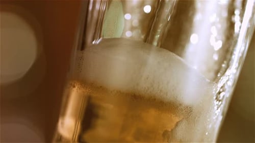 Beer Pouring into Glass in Macro Shot