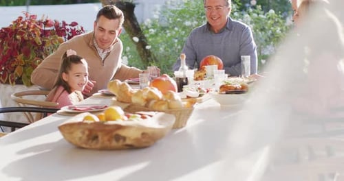 Multigenerational Family Sharing Meal Together Outside