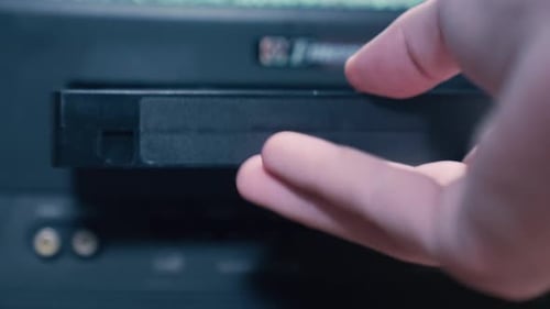 Inserting VHS Tape into Vintage VCR Player