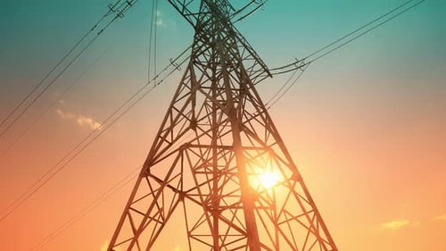 Transmission Tower Silhouette Against Vibrant Sunrise Sky