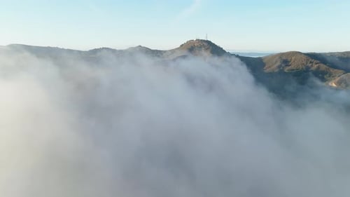 An Aerial Perspective of the Majestic Mountains Enveloped in a Mystical Foggy Atmosphere