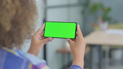 Close Up of Young African Woman Holding Phone with Green Screen