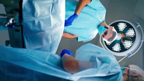 Doctor Looking Down at Patient in Operating Room