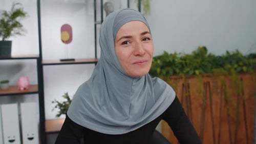 Smiling Woman Wearing Gray Headscarf Indoors