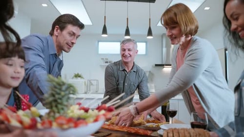 Family and Friends Gathering Around Dinner Table