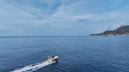 Aerial Video of a Speedboat Creating White Waves As It Moves Quickly Towards the Marina on a Sunny