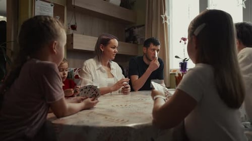 Family Enjoys Card Game Together at Home