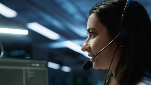 Woman Talking on Headset in Modern Office