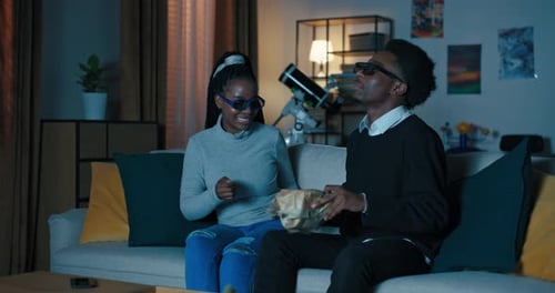 Happy Couple Enjoying a Movie Together at Home