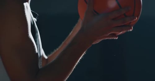 Cinematic slow motion close up shot of a professional young man is practicing basketball work out
