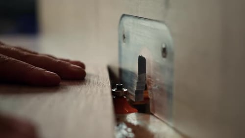 Machinist at Work Performing Tasks on Wood Shaper Close Up