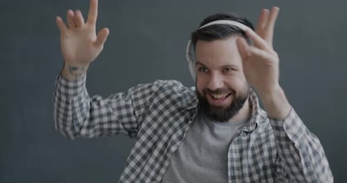 Young Adult Dances with Headphones On