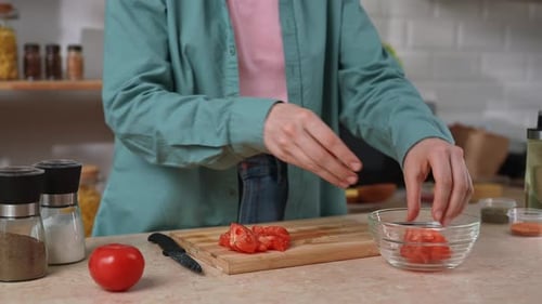 Woman Prepares Fresh Salad in Bright Kitchen