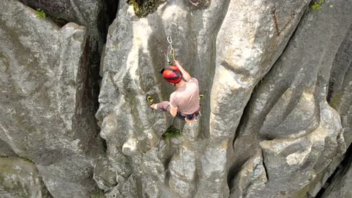 Young Man Climbing Steep Wall of Rocky Mountain Male Climber Overcomes Challenging Route Engaging in