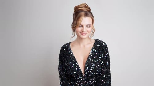 Glamorous Woman in Sparkly Dress Posing