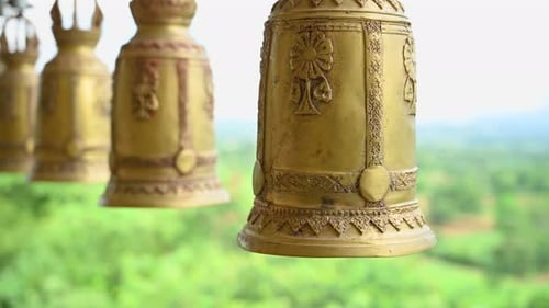 Buddhist Temple Bells or Thai Bells; hanging and swinging at the temple, spiritual people come to ri
