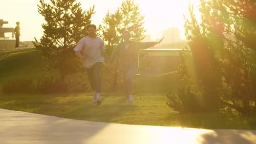 Young Couple is Engaging in Playful and Energetic Activities Running and Laughing in the Park During
