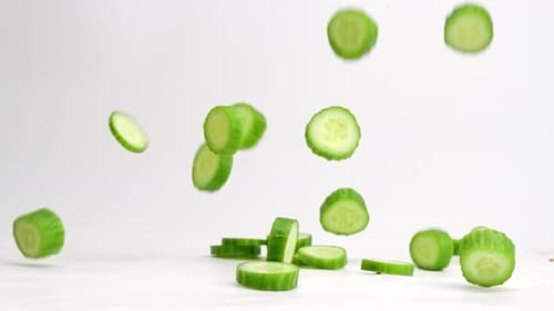 Cucumber Slices Falling in Slow Motion