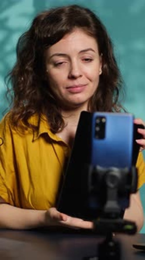 Woman Presents a Tablet in a Studio