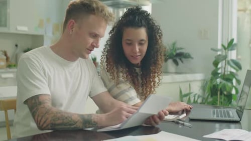 Young Couple Planning Finances Together at Home