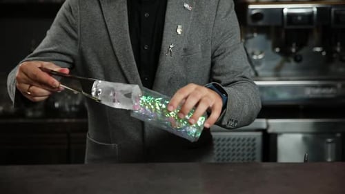 the bartender prepares a cocktail at the bar