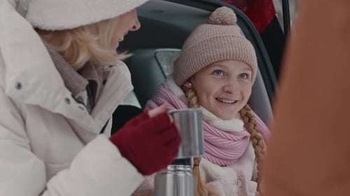 Woman and Child Drinking Hot Beverage in Winter