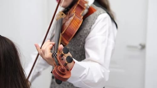Woman Plays Violin in Bright Room