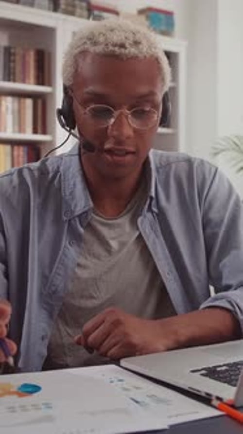 Professional African American Man with Headset Explaining Charts
